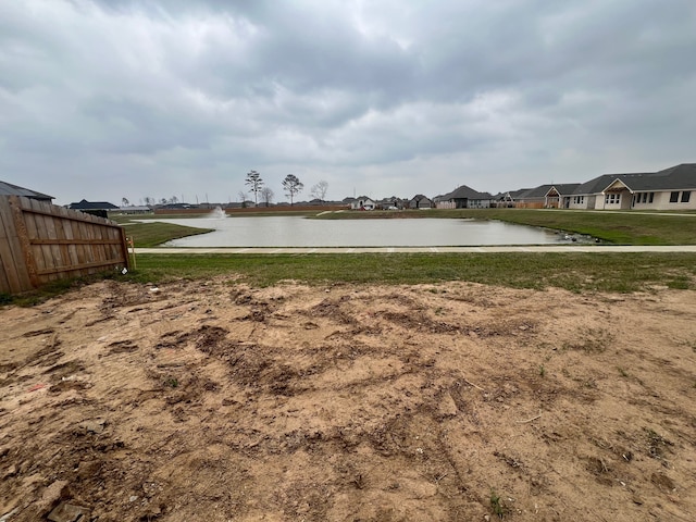 water view featuring a residential view and fence