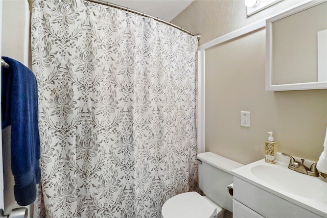 bathroom featuring vanity, toilet, and a shower with curtain