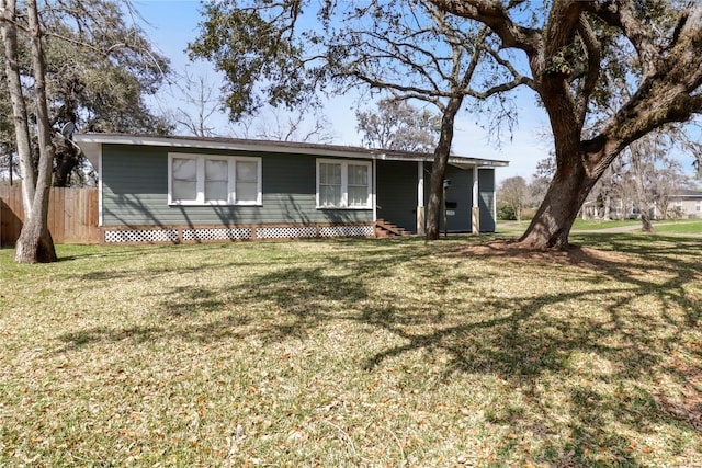 single story home with a front yard and fence