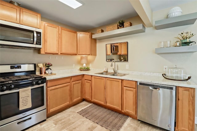 kitchen with open shelves, stainless steel appliances, light countertops, and a sink