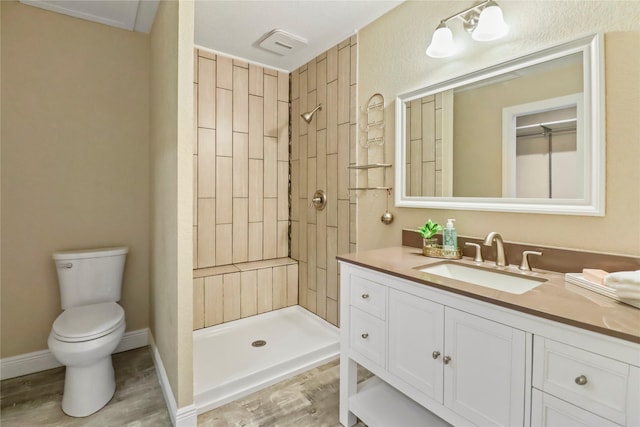 full bath featuring a shower stall, toilet, vanity, and wood finished floors