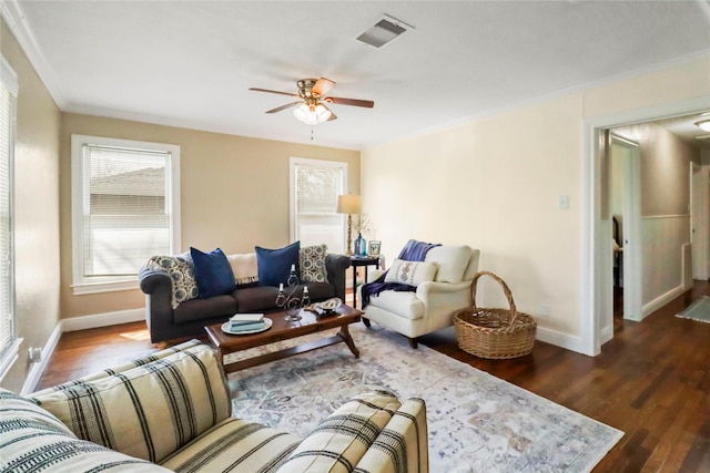 living room with visible vents, baseboards, wood finished floors, and a ceiling fan