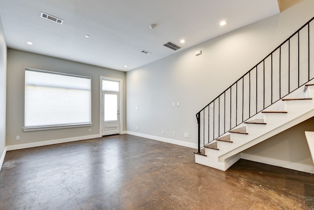 foyer entrance with recessed lighting, visible vents, baseboards, and finished concrete flooring