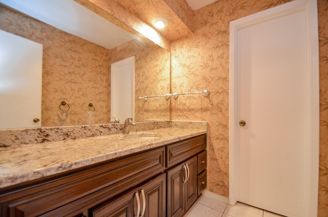 bathroom with tile patterned flooring, vanity, and wallpapered walls