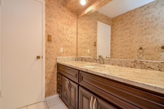 bathroom with vanity, tile patterned flooring, and wallpapered walls