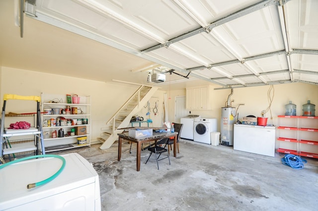 garage featuring gas water heater, a garage door opener, and independent washer and dryer