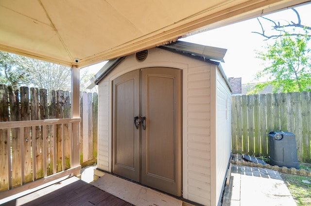 view of shed featuring fence