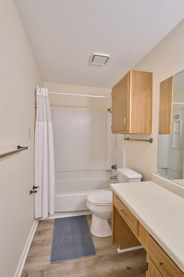 full bath with vanity, toilet, shower / tub combo with curtain, and wood finished floors