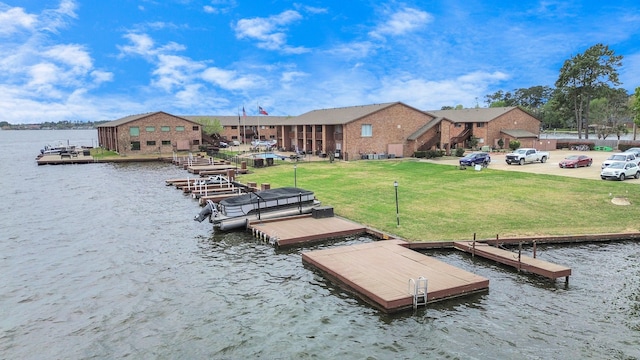 view of dock featuring a water view and a lawn