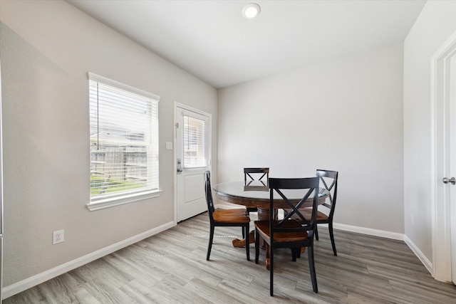 dining area with wood finished floors and baseboards