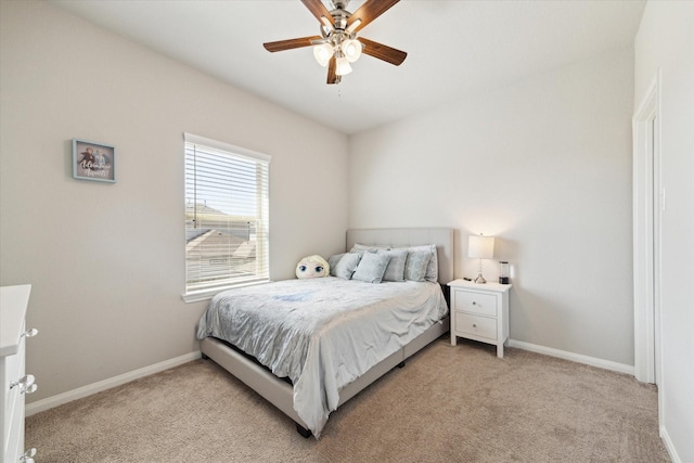 bedroom with light carpet, ceiling fan, and baseboards