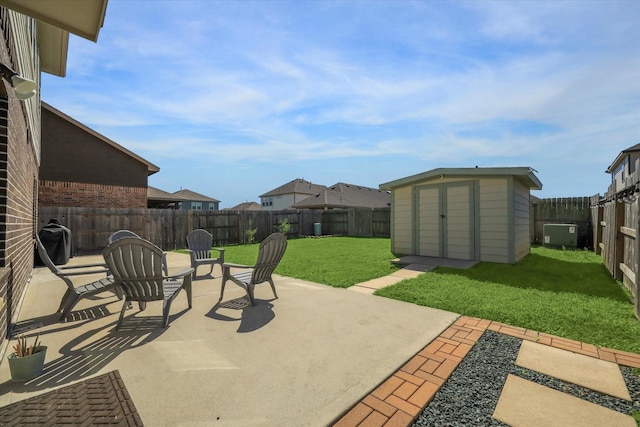 view of patio with an outbuilding, a shed, a grill, and a fenced backyard