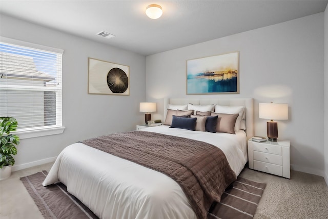 bedroom featuring visible vents, baseboards, and carpet