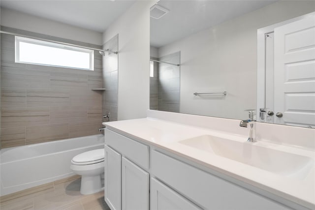 bathroom with vanity, toilet, tub / shower combination, and visible vents