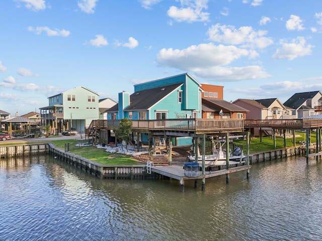 dock area featuring a yard, a residential view, and a deck with water view