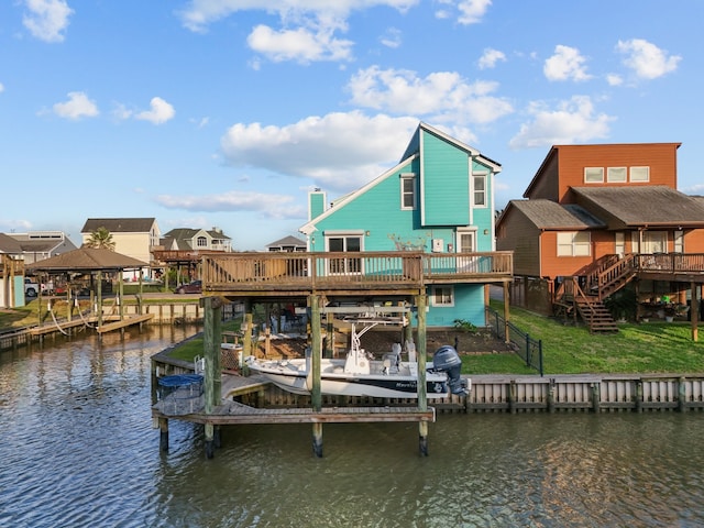 view of dock featuring stairway, a residential view, a lawn, boat lift, and a deck with water view