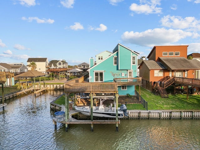 dock area with stairway, a deck with water view, boat lift, a lawn, and a residential view