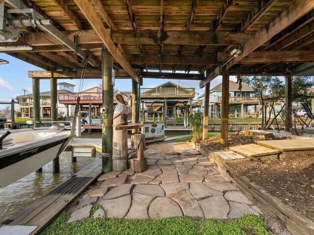 dock area with a water view and boat lift