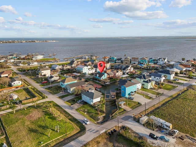 drone / aerial view featuring a residential view and a water view