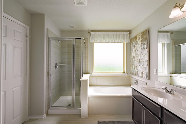 full bath featuring visible vents, a shower stall, vanity, and a garden tub