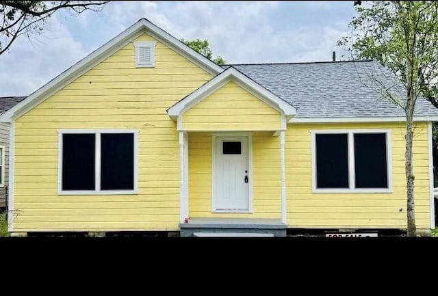 view of front of property featuring roof with shingles