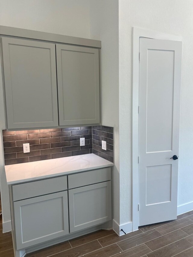 2214 Elm Ridge Trl, Tomball, TX 77375 - kitchen with wood tiled floors, tasteful backsplash, and light countertops