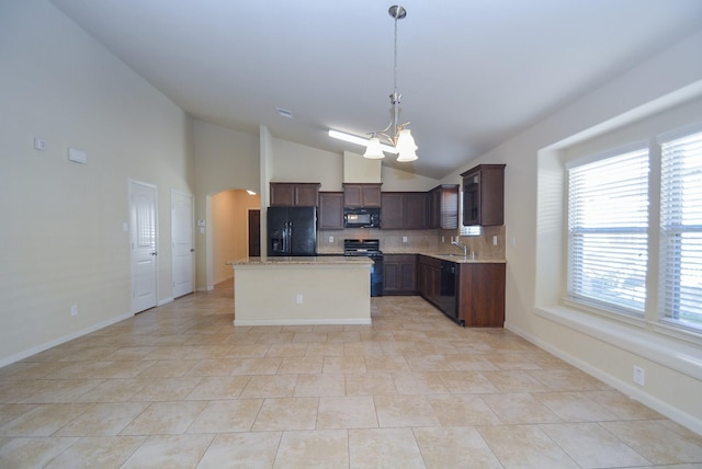 kitchen with a kitchen island, pendant lighting, a notable chandelier, black appliances, and a sink