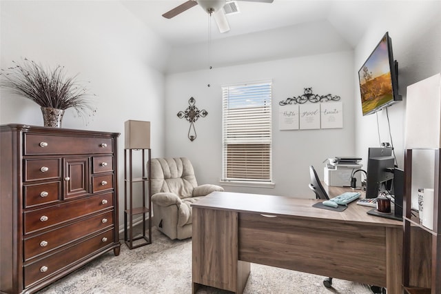 office featuring visible vents, light carpet, lofted ceiling, and ceiling fan