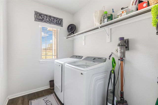 laundry room with laundry area, wood finished floors, baseboards, and washing machine and clothes dryer