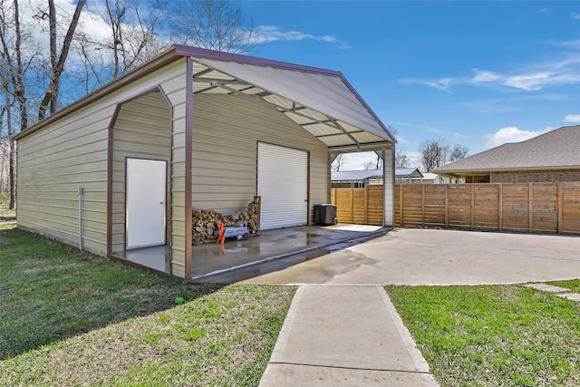 view of outbuilding featuring an outbuilding and fence