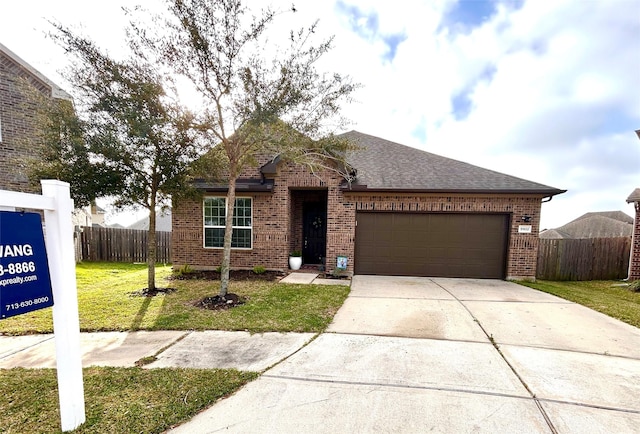 single story home featuring a front yard, fence, concrete driveway, a garage, and brick siding