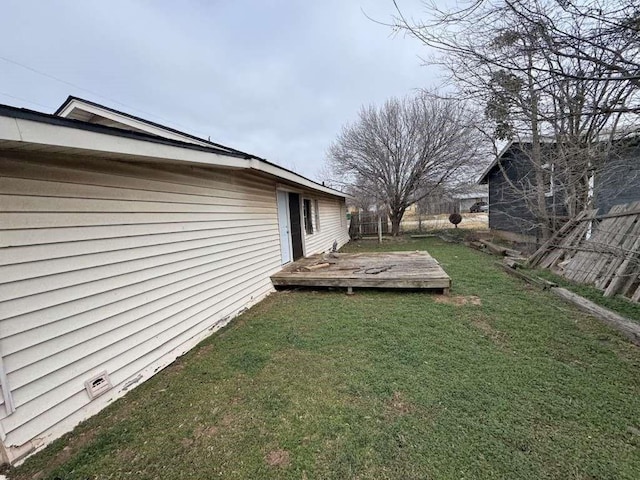 view of yard with a wooden deck and fence