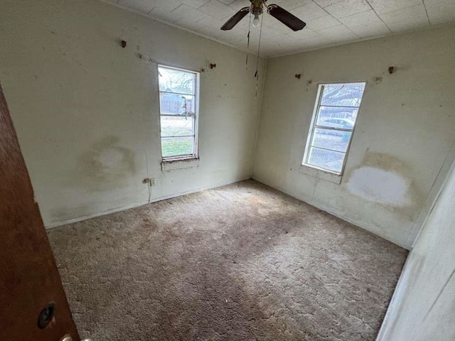 empty room featuring carpet floors and a ceiling fan