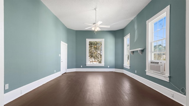 spare room featuring baseboards, a textured ceiling, dark wood-style flooring, and a ceiling fan