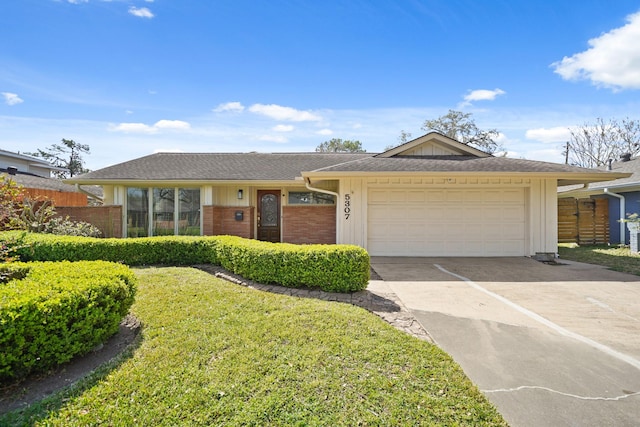 ranch-style home featuring an attached garage, concrete driveway, board and batten siding, and fence