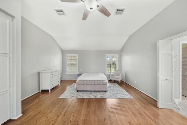 unfurnished bedroom with light wood-type flooring, visible vents, and lofted ceiling