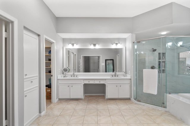 bathroom featuring a sink, double vanity, and a shower stall