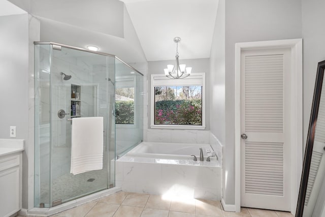 full bath featuring an inviting chandelier, vaulted ceiling, a bath, and a shower stall