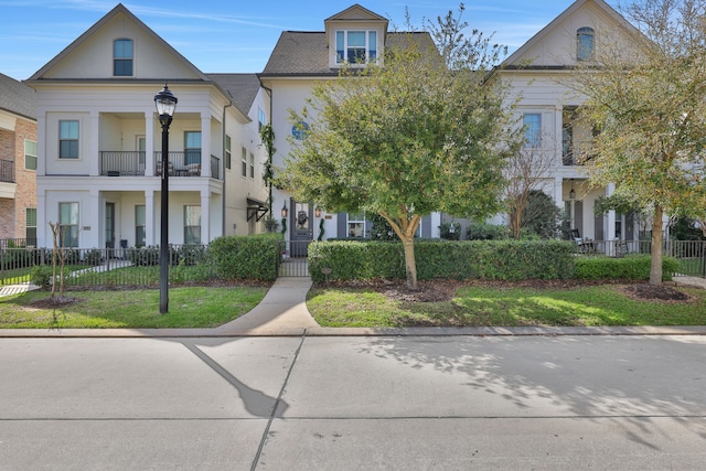 neoclassical home with a fenced front yard and stucco siding