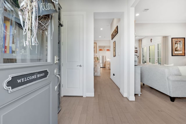 hallway featuring visible vents, recessed lighting, light wood-type flooring, and baseboards