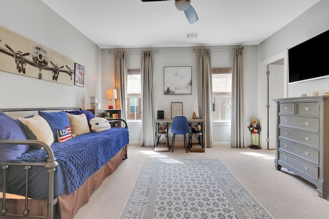 bedroom with visible vents, a ceiling fan, and carpet