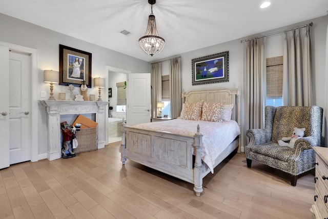 bedroom featuring visible vents, an inviting chandelier, recessed lighting, light wood-type flooring, and connected bathroom