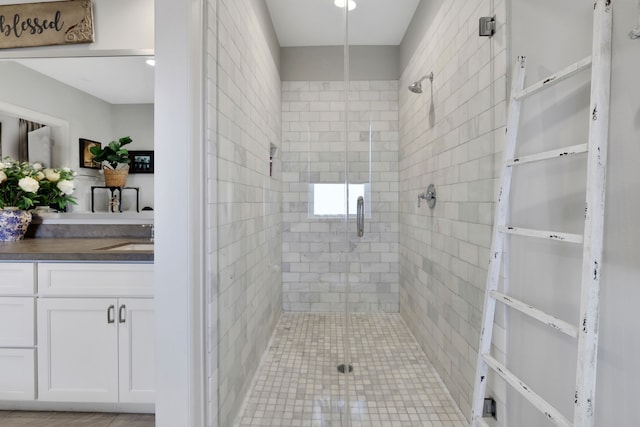 full bathroom with vanity and a shower stall