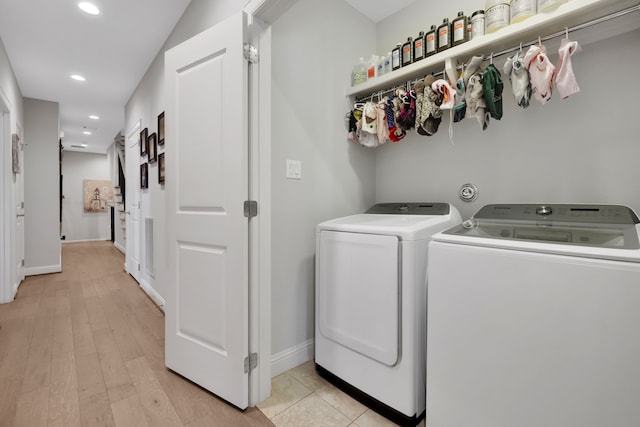 laundry area with baseboards, light wood-type flooring, laundry area, recessed lighting, and separate washer and dryer