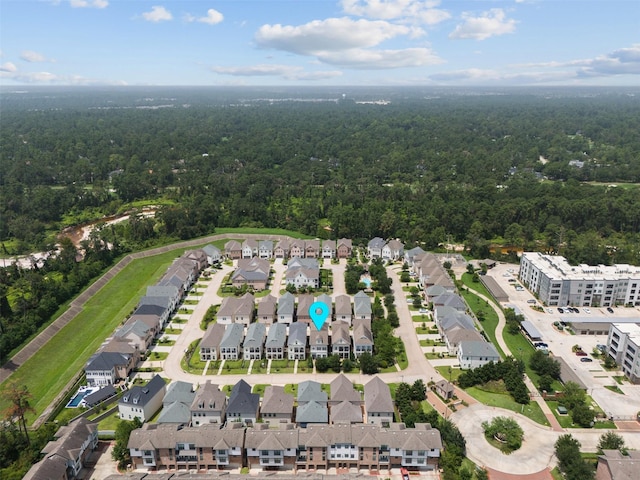 aerial view featuring a residential view and a wooded view