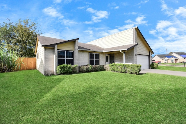 view of front of home featuring a front yard, fence, concrete driveway, a garage, and brick siding