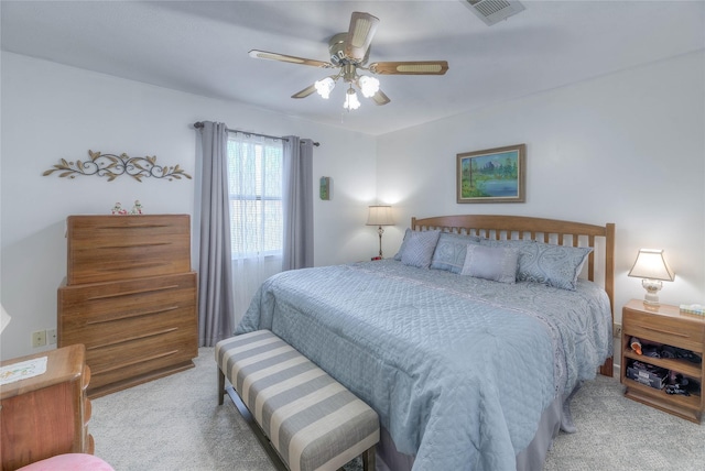 bedroom with carpet, visible vents, and ceiling fan