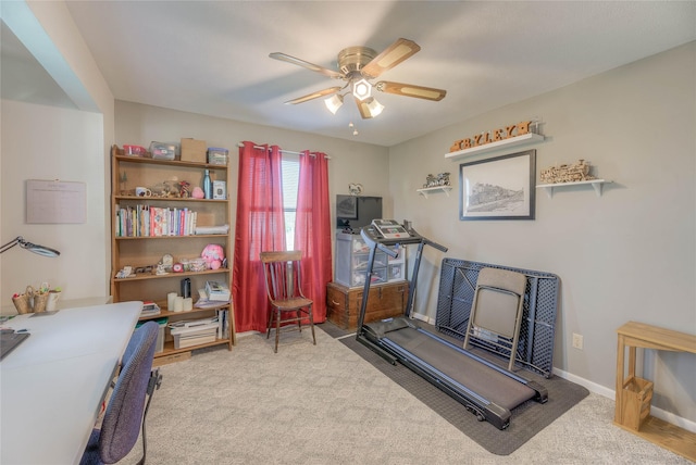 workout area featuring a ceiling fan, carpet, and baseboards