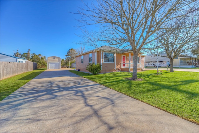 view of front of home featuring a front lawn, driveway, fence, an outdoor structure, and a garage