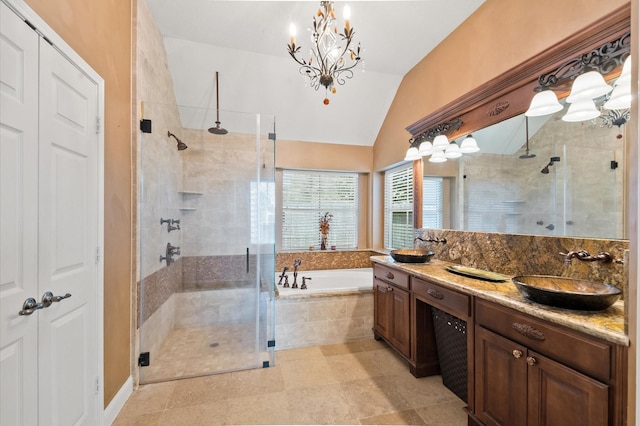 full bath featuring a sink, a shower stall, vaulted ceiling, a bath, and a chandelier